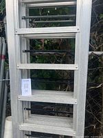 Full view of one folded aluminum ramp section leaning upright