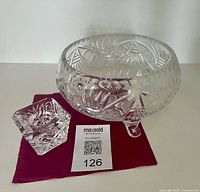 footed cut crystal bowl and cube candle holder on cloth