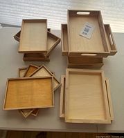 Assorted wooden trays stacked by size and depth
