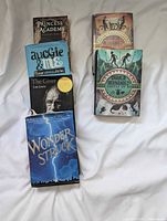 All six hardcover books arranged on surface