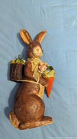 Front view of standing bunny figurine with cone basket and rear basket visible