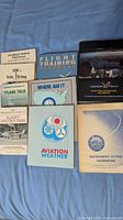 All eight flight training books laid out