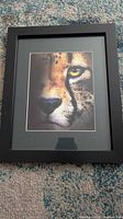 Framed cheetah close-up print in black frame