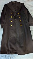 Full view of naval great coat laid flat