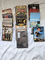 All fifteen books laid out on white surface, spines and covers visible