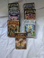 Front view of all seven books arranged standing and lying flat