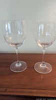 Two lead crystal goblets on wooden surface