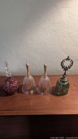 Group shot of all four crystal bells on wooden surface