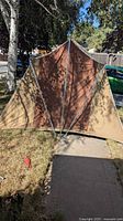 Front view of assembled brown and tan vintage tent with aluminum frame
