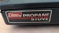 Coleman logo decal on stove lid