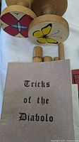 Wooden diabolo ends, handsticks and Tricks of the Diabolo booklet