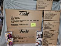 Overview showing stacked Funko master cases and four individual Pops