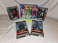 Group shot of all five sealed action figure packages