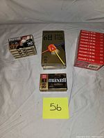 Stack of four sealed Maxell XLII 90 cassettes, one Memorex E-HG T-120 VHS, Maxell XLII 90 multi-pack, Maxell UR90 10-pack visible