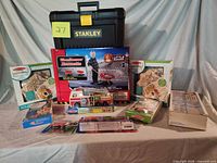 Overall lot with boxed wheelbarrow, craft kits, puzzle, vehicle toys