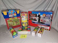 All seven packaged toy items displayed on grey backdrop