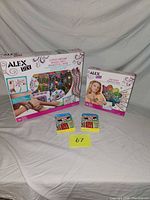 Group shot of both Alex DIY kits and two Monopoly card games