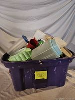 Purple tote filled with assorted vintage Tupperware pieces