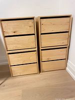 Front view of four stacked wooden cube storage drawers showing six drawers visible and the natural wood finish.