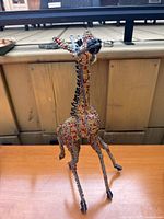 Front angle showing detailed front and side beadwork on the giraffe sculpture.