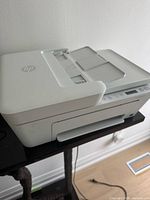 Side and top angled view of HP DeskJet 4152e printer showing the automatic document feeder and scanning lid, overall good physical condition.