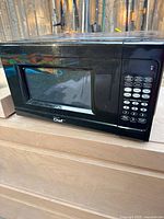 Front view of black Master Chef microwave oven showing door, window, and digital control panel.