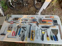 Overview of all hand tools laid out on table showing full lot content