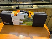 Overall view of the volleyball and badminton set packed in its original black zippered carry bag with orange handles and visible product label.