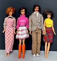 Front view of four fashion dolls