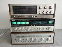 Front view of stacked Kenwood KR-6340, Technics SA-8100X and Yamaha CR-820 receivers