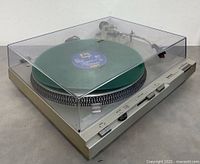 Turntable with dust cover closed and green demo vinyl (vinyl not included)