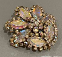 Front view of the brooch showing the cluster of iridescent marquise and round rhinestones.