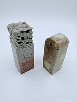 Two jade seal chops standing side by side