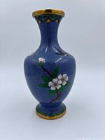 Front view showing floral branch design and blue cloud background