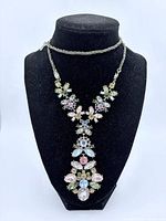 Front view of multicolour rhinestone floral necklace on stand
