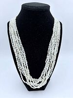 Full view of necklace on display bust showing multi-strand design