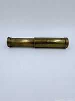 Side view of fully collapsed brass pocket telescope