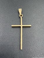 Front view of gold cross pendant