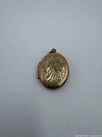 Front view engraved floral oval locket