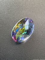 Front view of oval mystic topaz showing rainbow colours