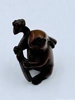 Front view of carved rabbit netsuke holding mushroom