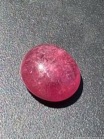 Top view of ruby cabochon on neutral background