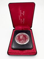 Coin in open presentation case, reverse side visible showing 1952-1977 dates