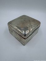 closed sterling silver box showing monogram and surface condition