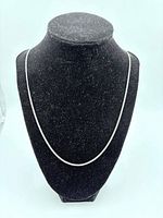 Curb-style sterling silver chain on display bust