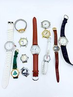 All twelve watches laid out on white background