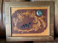 Front view showing tooled leather design, frame, artist signature