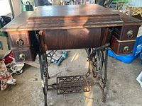 Full view of treadle sewing machine cabinet and base
