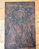 Entire artwork showing geometric sun, mountains and plants