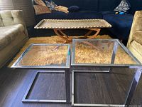 Both chrome and glass nesting tables shown side by side